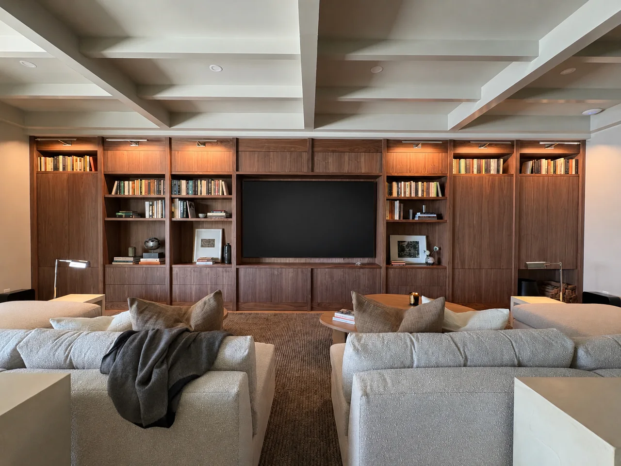 Breeze Bay media room with integrated television and custom walnut millwork