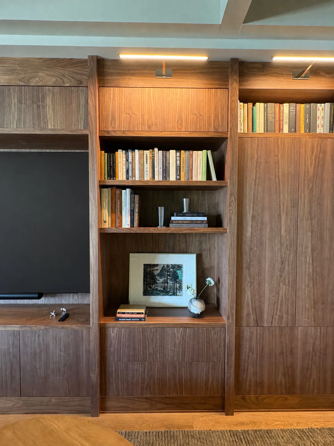 Detail of illuminated walnut millwork surrounding the Breeze Bay television
