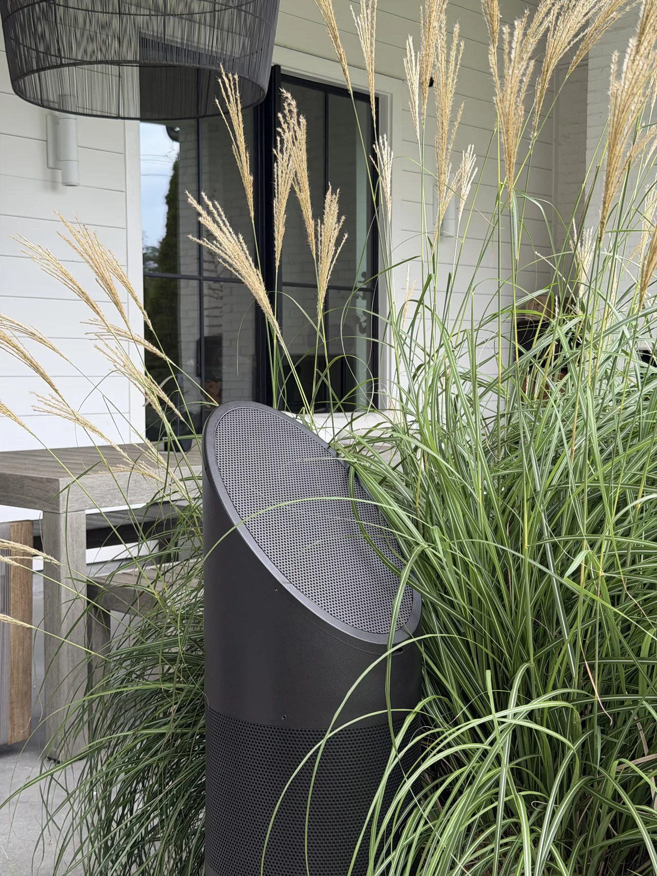 Discreet outdoor speaker integrated into ornamental grasses