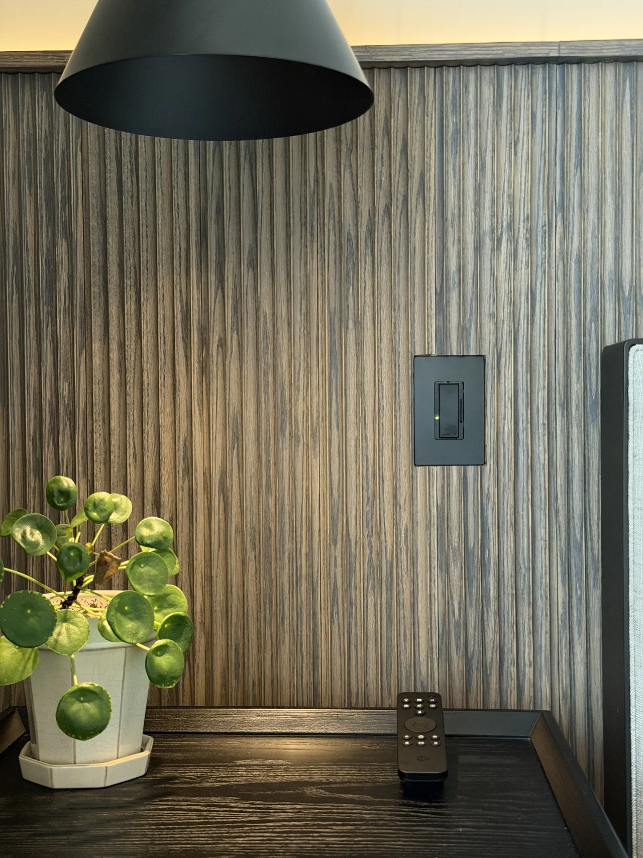 Lutron dimmer and Josh.ai remote beside the bed