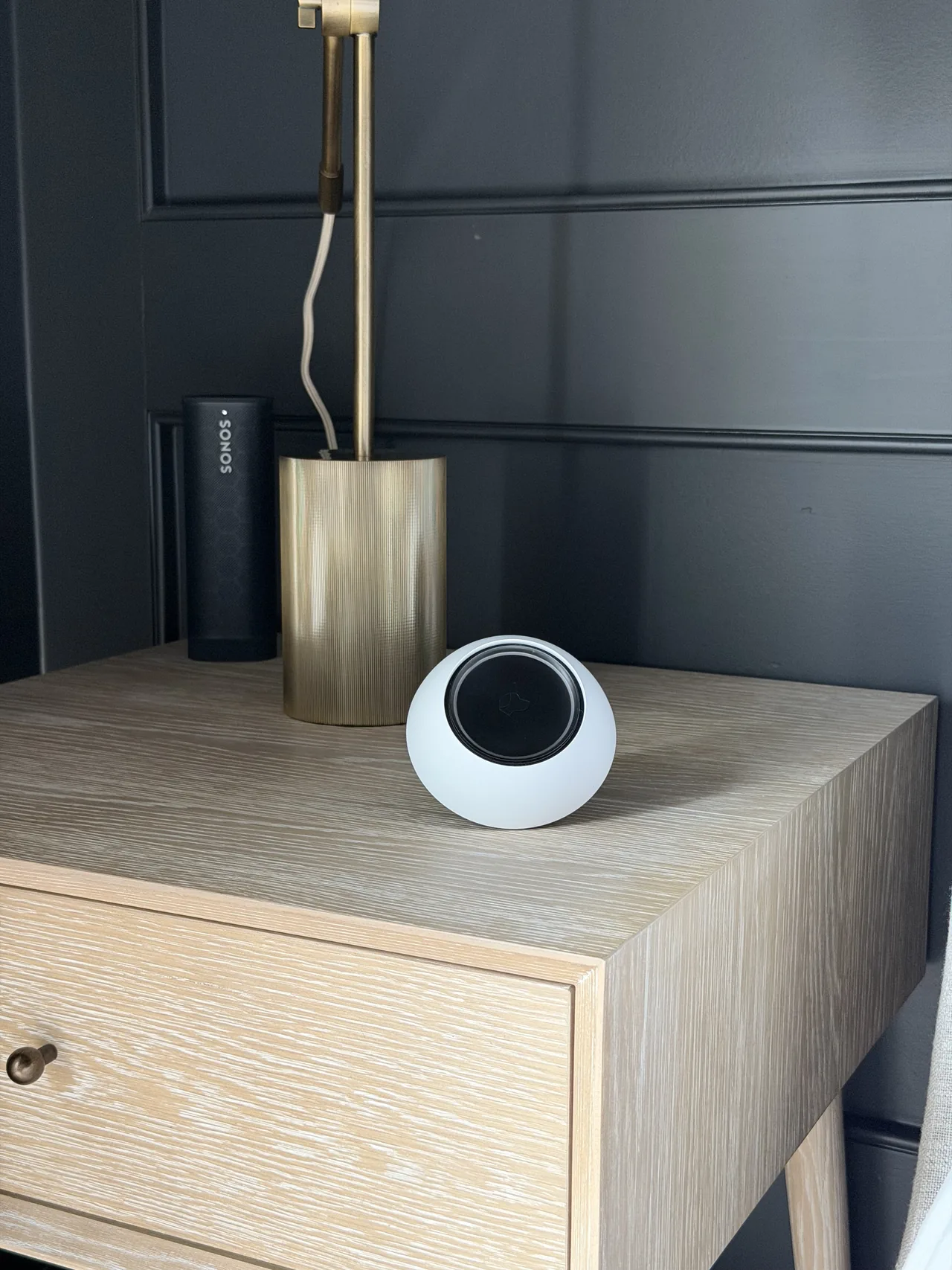 Sonos speaker and Josh.ai control device on a bedside table